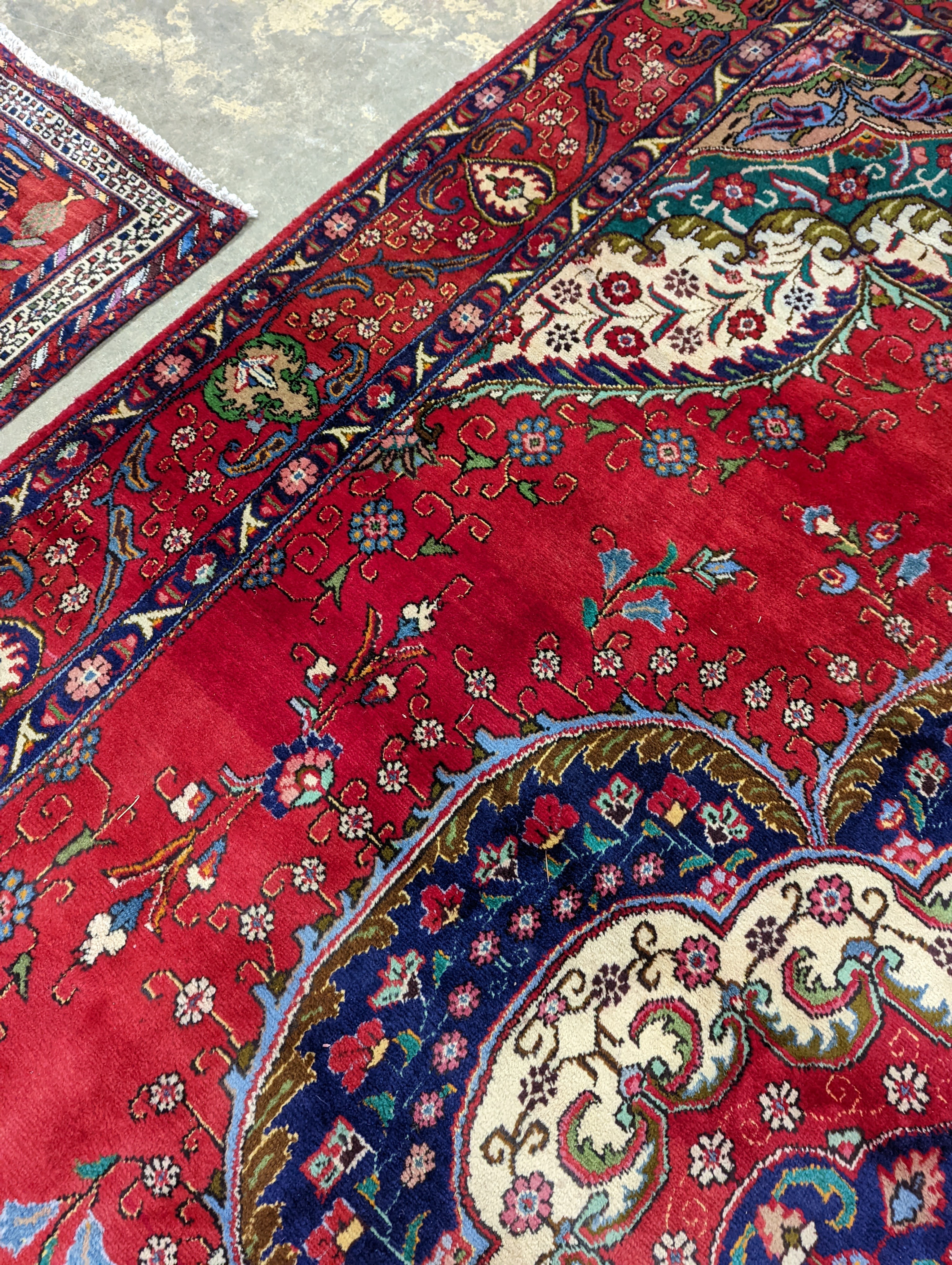 A Tabriz red ground carpet, 380 x 300cm